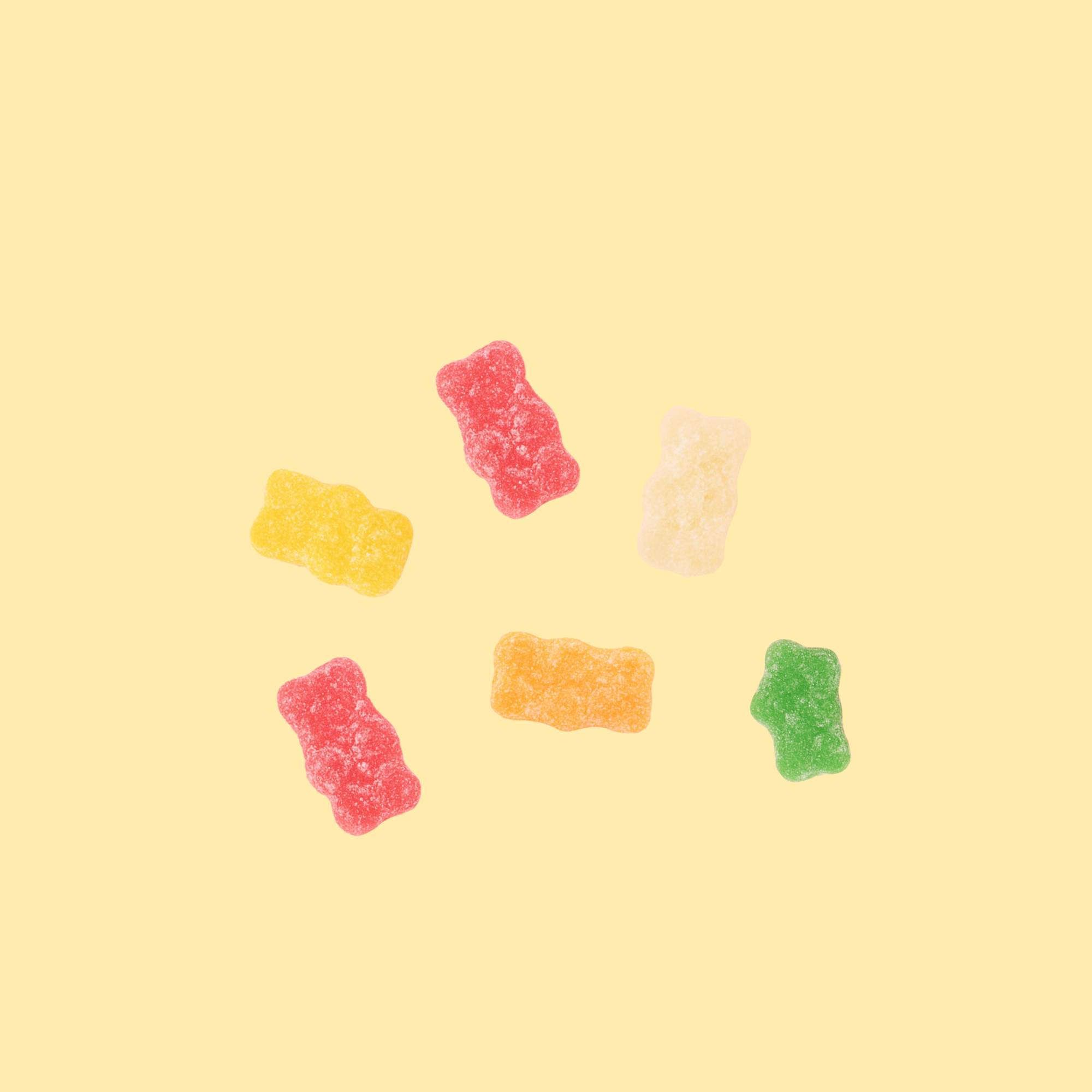 Colorful gummy bears on a yellow background