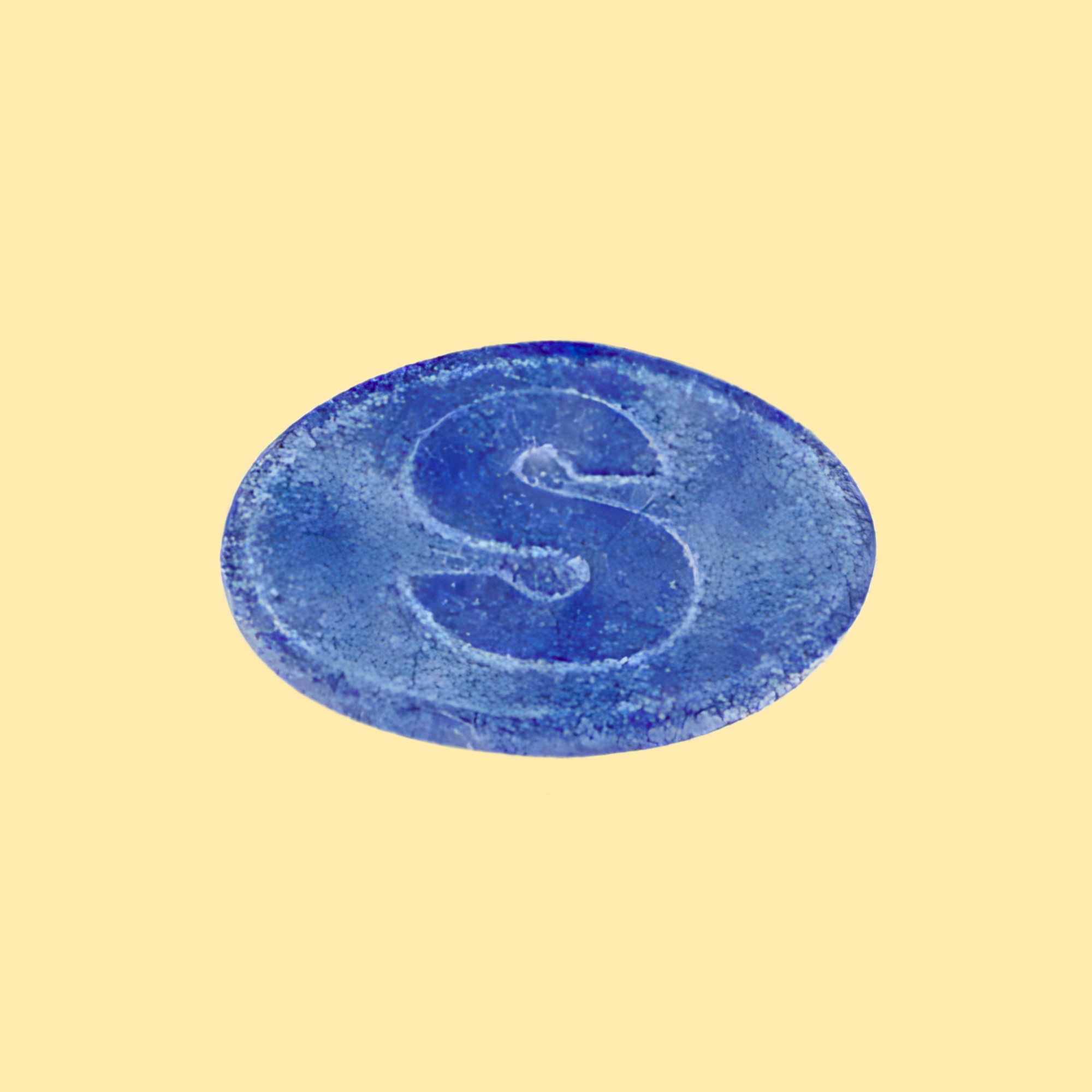 Blue circular object with a letter 'S' on a beige background