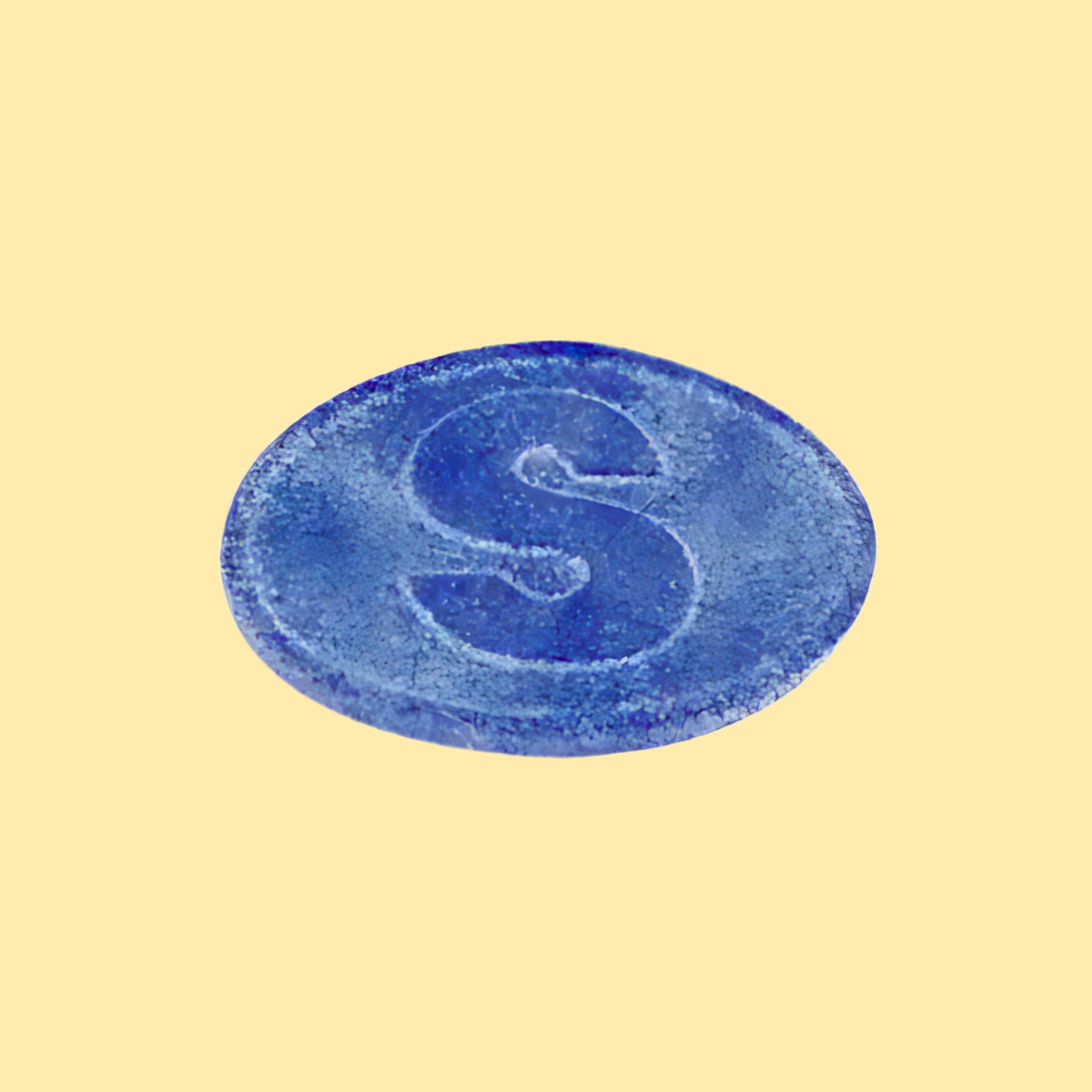 Blue circular object with a letter 'S' on a beige background